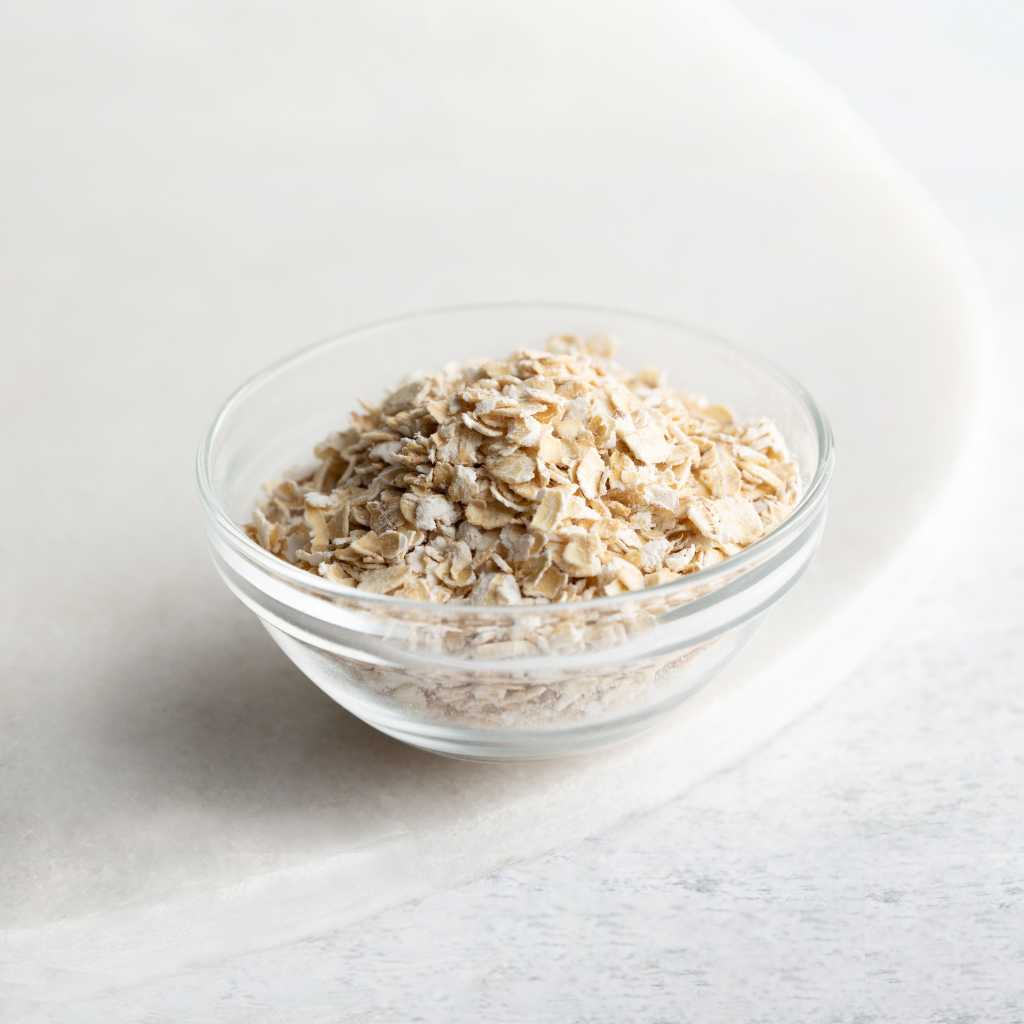 Scottish porridge oats in a clear glass bowl used in our natural skincare for dry and sensitive skin