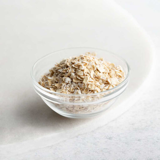 Scottish porridge oats in a clear glass bowl used in our natural skincare for dry and sensitive skin
